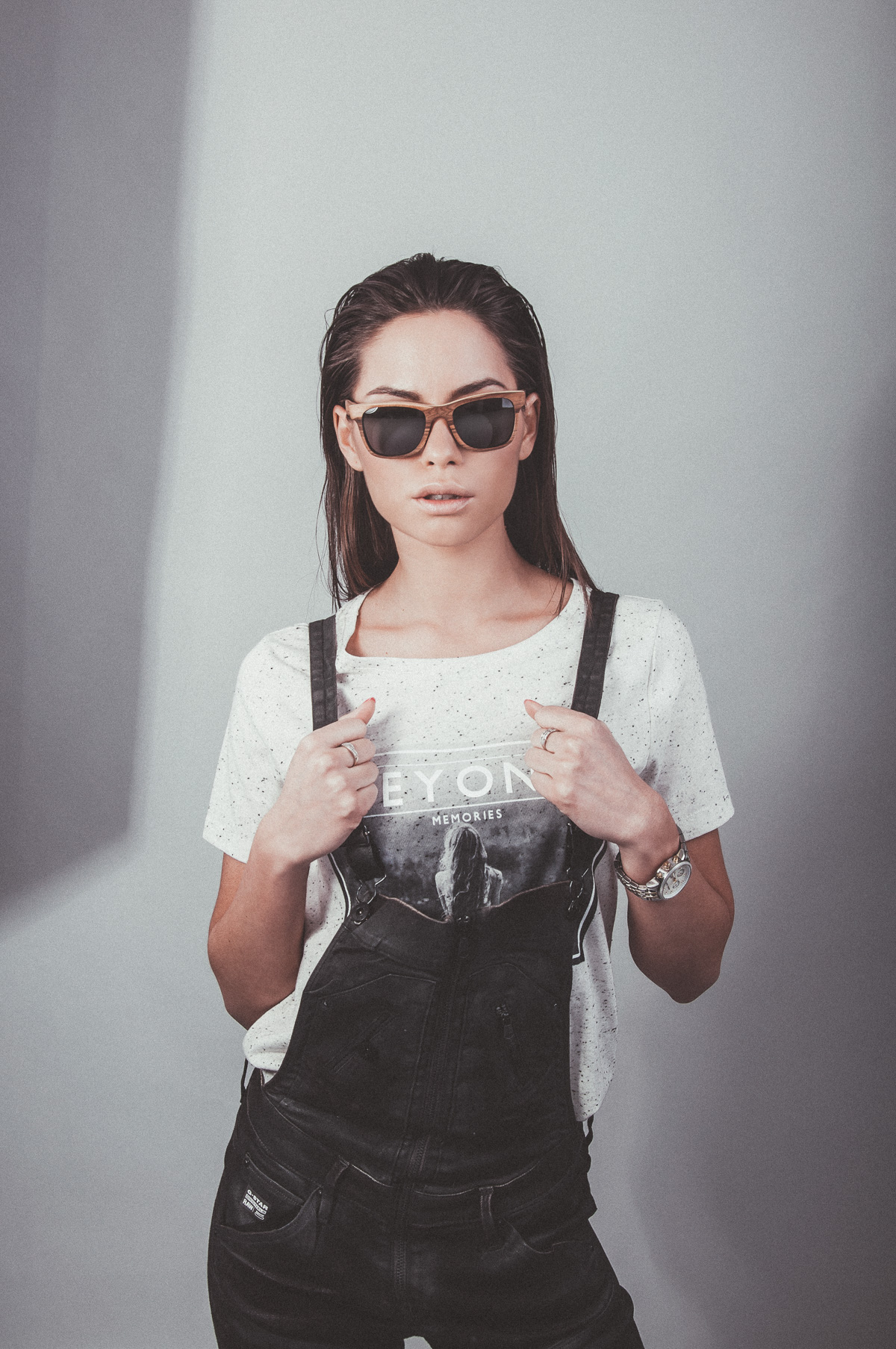 A woman wearing wooden Pray sunglasses, studio portrait from the See Through Nature campaign