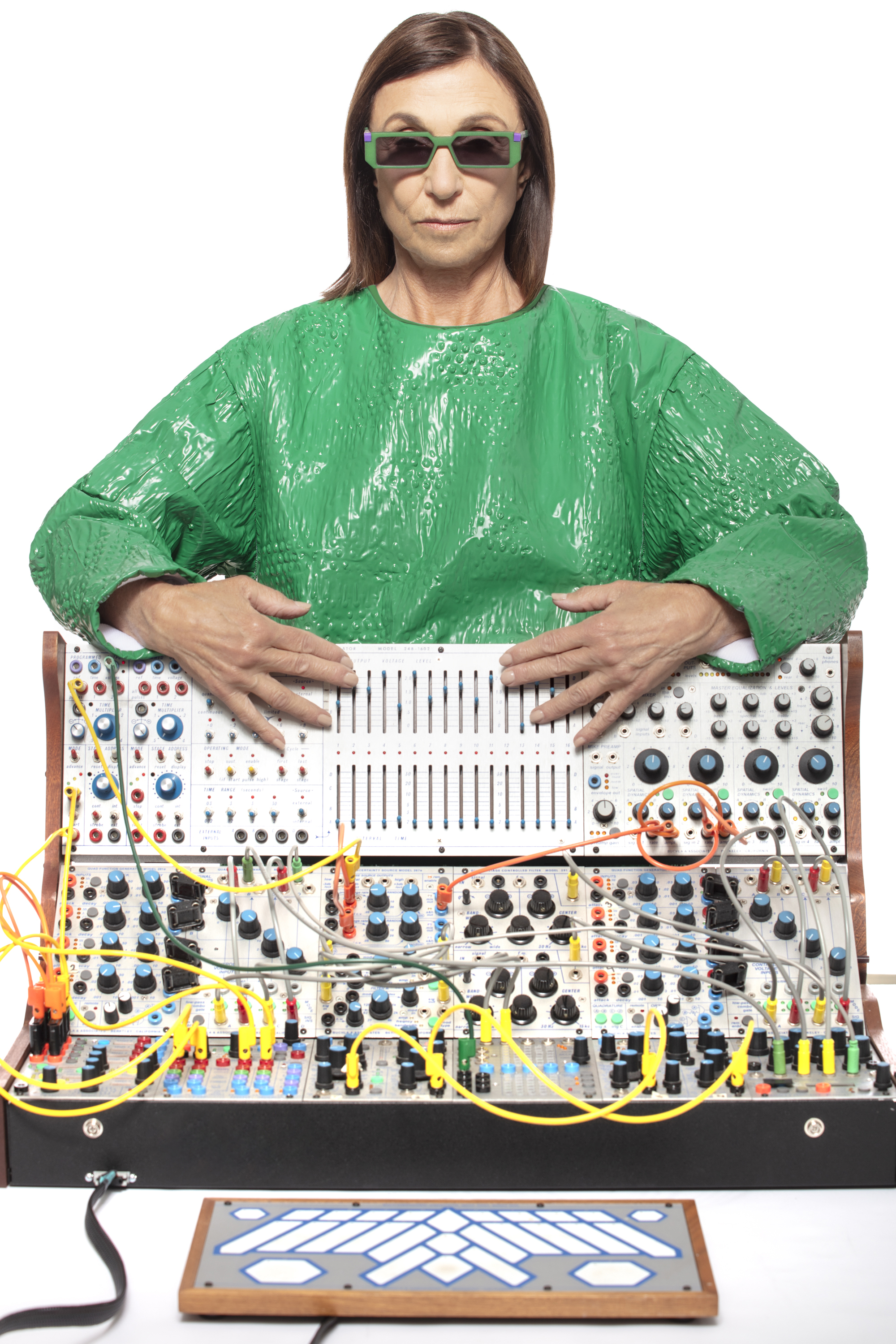 Suzanne Ciani at her modular synthesizer, wearing green rectangular VAVA glasses